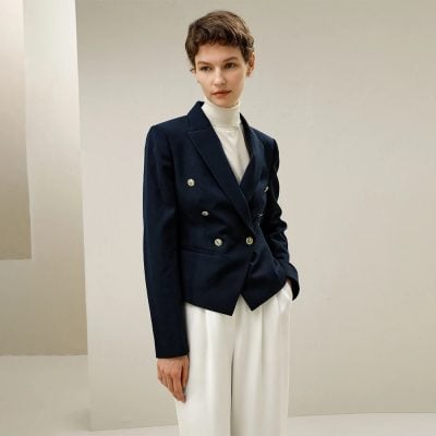 Elegant woman wearing a navy tailored blazer and white pants for sophisticated fashion style. Perfect for business and formal occasions. Monalisa Store offers stylish, high-quality clothing options for women.