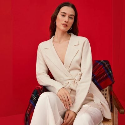 Elegant woman in cream-colored outfit showcasing stylish fashion accessories at Monalisa Store for modern women's apparel and accessories.