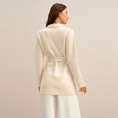 Elegant cream-colored women's blazer with a belt, perfect for professional or formal occasions. Stylish, tailored, and versatile, crafted for a sophisticated look.