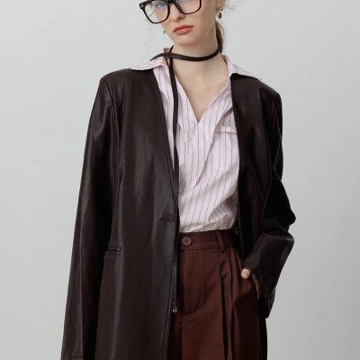 Stylish woman wearing fashionable blue light blocking glasses and a leather jacket, showcasing modern optical eyewear from Monalisa Store, perfect for professional and casual looks.