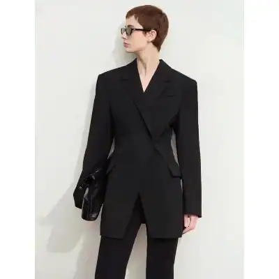 Stylish woman in black blazer and trousers wearing glasses, showcasing fashionable eyewear and professional attire at Monalisa Store.