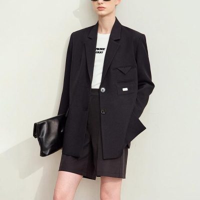 Black blazer with oversized fit, paired with black shorts and sunglasses, showcasing modern women's fashion at Monalisa Store. Perfect for stylish office or casual wear.