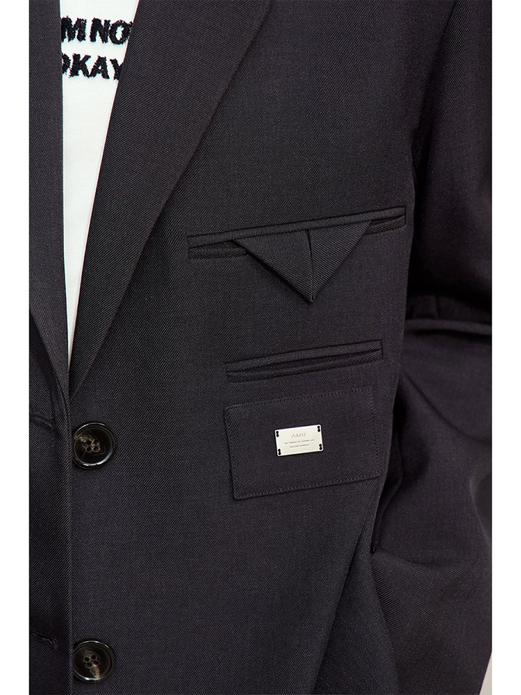 Elegant black suit jacket with stylish pocket details, tailored for professional and formal wear, available at Monalisa Store.