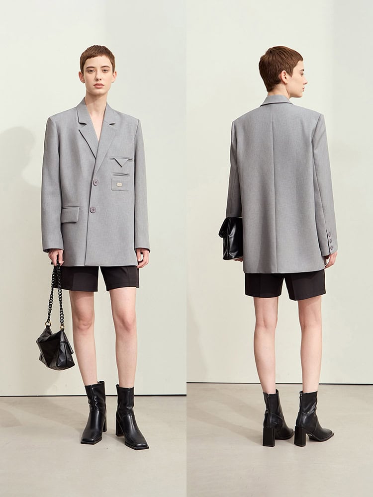 Gray oversized blazer with black shorts and ankle boots, styled for a modern yet sophisticated look at Monalisa Store. Perfect for fashion-forward individuals seeking chic, versatile wardrobe essentials.