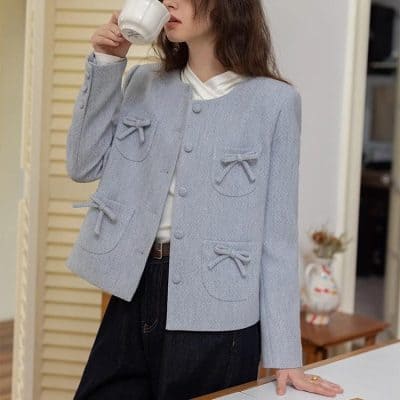 Polished light blue tweed jacket with bows, stylish women's fashion, Monalisa Store, elegant casual wear, trendy outerwear, women's designer jacket, sophisticated clothing, modern boutique fashion.