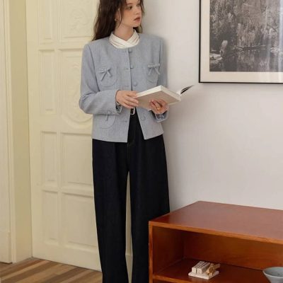 Elegant woman reading a book at Monalisa Store showcasing sophisticated fashion and stylish interior decor.