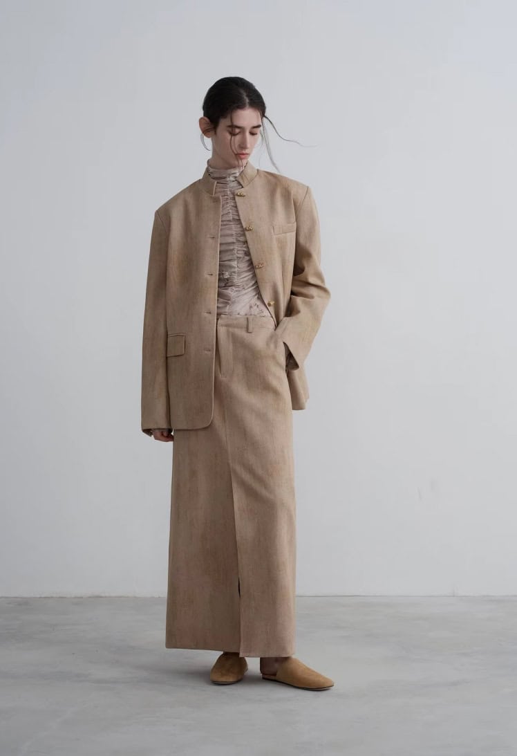 Cashmere beige women's business suit with blazer and long skirt, elegant professional attire, minimalist fashion style, suitable for office wear or formal occasions.