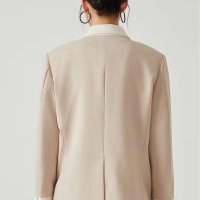 Elegant beige women's blazer with a tailored fit, perfect for professional and stylish office wear, featuring a classic lapel and comfortable design.