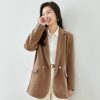 Elegant woman in brown blazer and white shirt, fashionable and professional look for outdoor or office wear - Monalisa Store optical accessories and stylish apparel.