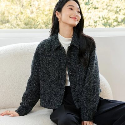 Stylish woman sitting on a cream sofa with a backdrop of trees, showcasing contemporary fashion at Monalisa Medical Store for optometry accessories.