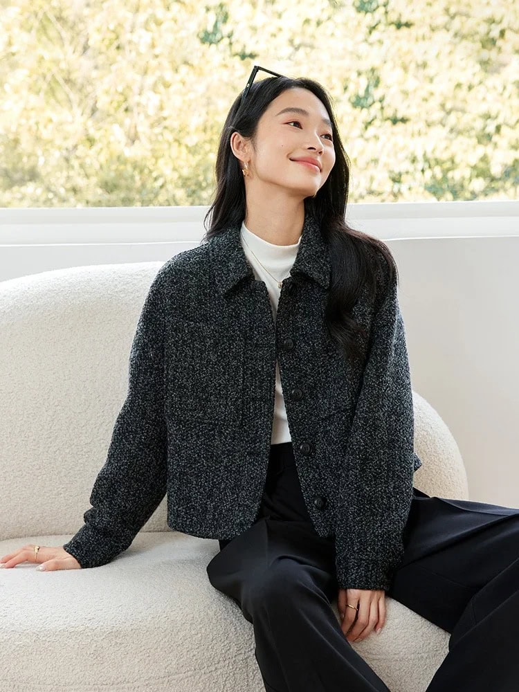Stylish woman sitting on a cream sofa with a backdrop of trees, showcasing contemporary fashion at Monalisa Medical Store for optometry accessories.