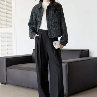 Black jacket and high-waisted wide-leg trousers styled for a modern, fashionable look, perfect for retail or fashion store displays.
