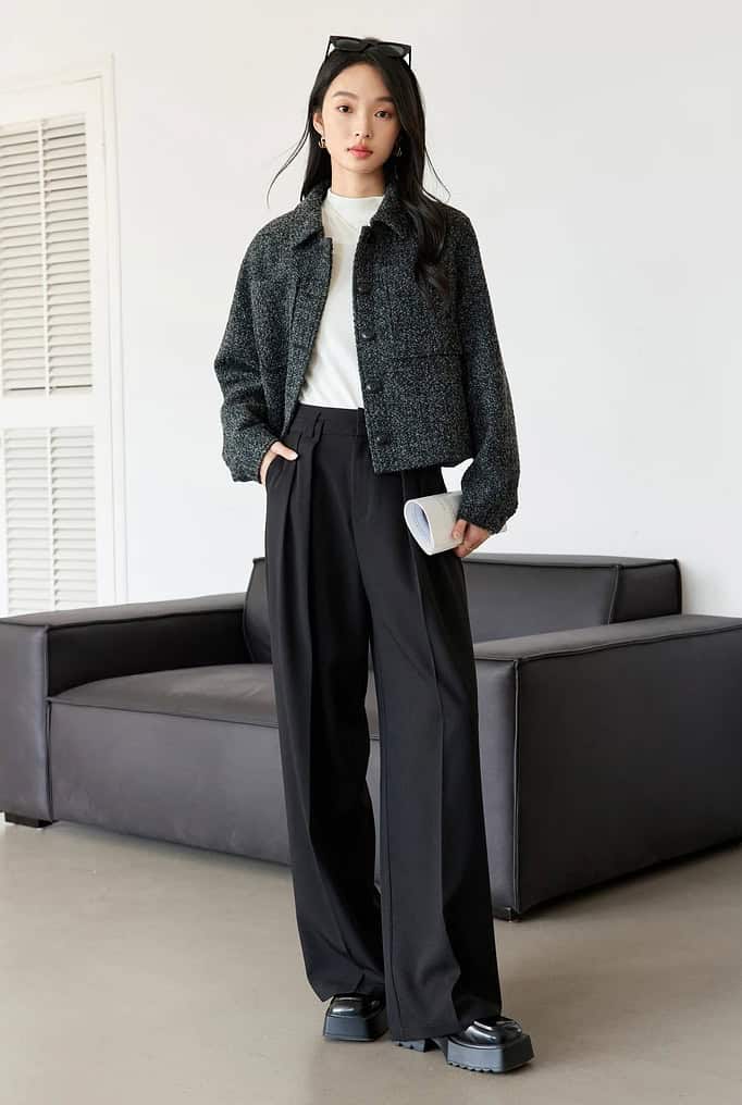 Black jacket and high-waisted wide-leg trousers styled for a modern, fashionable look, perfect for retail or fashion store displays.
