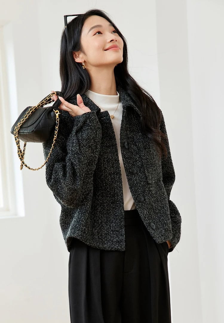 Luxurious designer handbag with gold chain detail, styled for a modern elegant look, perfect for fashion-forward women.