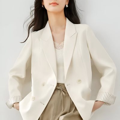 Elegant woman in a white blazer and beige pants, showcasing professional office fashion suitable for work, meetings, or business casual settings.