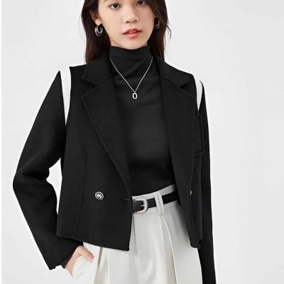 Stylish woman in black blazer and white high-waisted trousers, showcasing modern fashion from Monalisa Store, ideal for professional or casual attire.