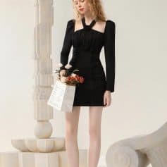 Elegant black dress with long sleeves and floral embellishments, perfect for fashionable women.