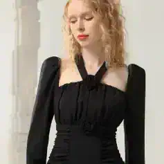 Elegant black evening dress with ruched detailing and floral accents, perfect for special occasions or formal events. Suitable for upscale fashion showcases and stylish women.