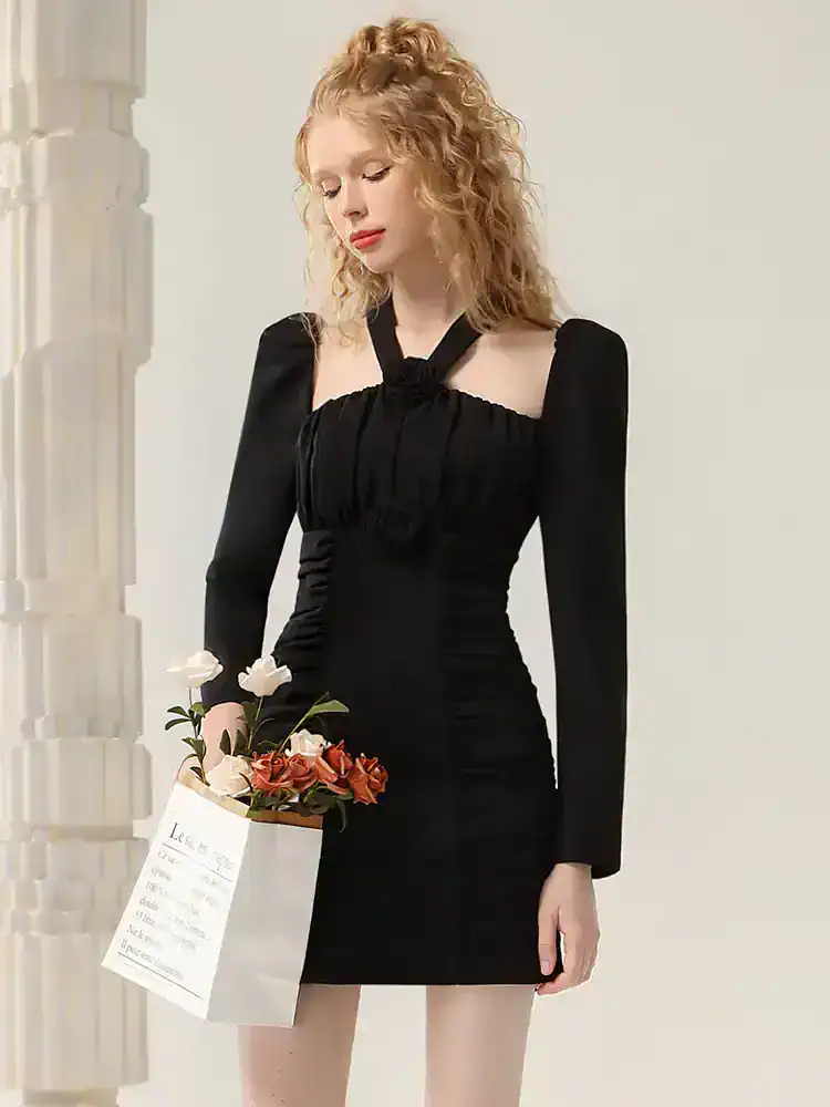 Elegant black dress with long sleeves and unique neckline, perfect for fashionable occasions or casual wear. Monalisa Medical offers stylish options for women seeking comfort and sophistication.