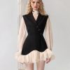 Elegant women's fashion dress with black and beige design, ruffled hem, and stylish puffy sleeves, perfect for modern chic look and formal occasions.