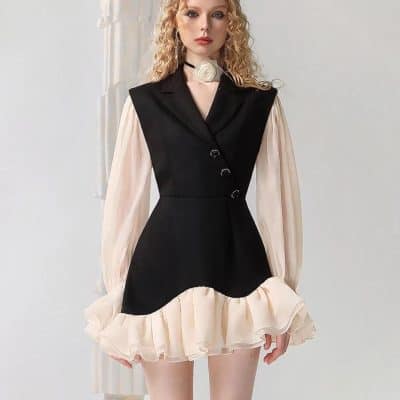 Elegant women's fashion dress with black and beige design, ruffled hem, and stylish puffy sleeves, perfect for modern chic look and formal occasions.
