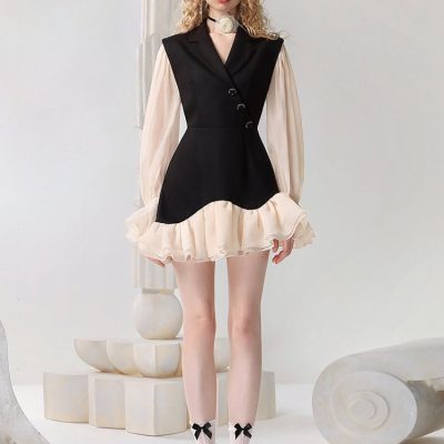 Elegant black and ivory ruffled dress with puffed sleeves, perfect for fashion-forward women. Features stylish details with a trendy, modern silhouette and eye-catching design, suitable for special occasions or fashionable outings.