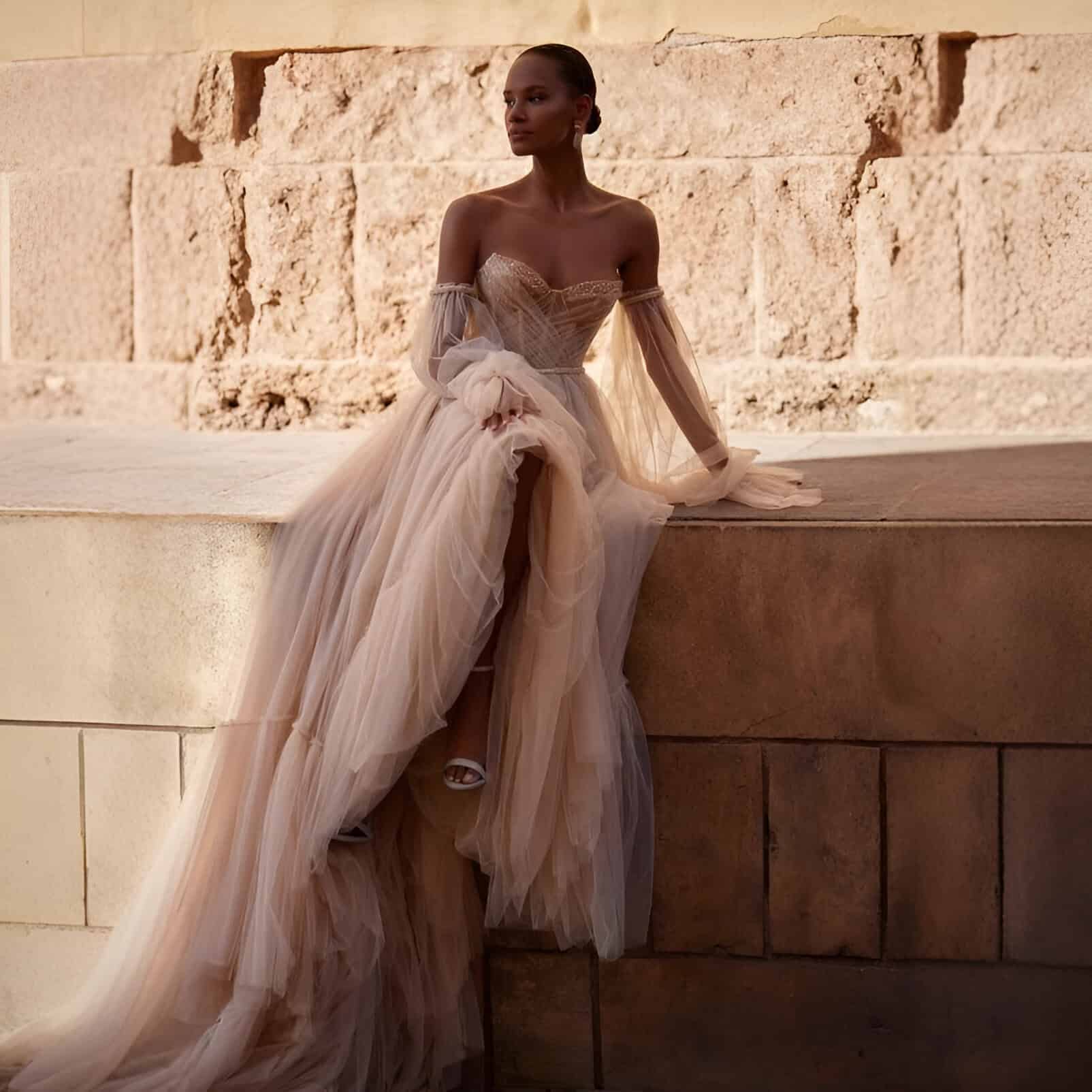 Elegant wedding gown with tulle layers and off-shoulder design, perfect for bridal fashion at Monalisa Store.