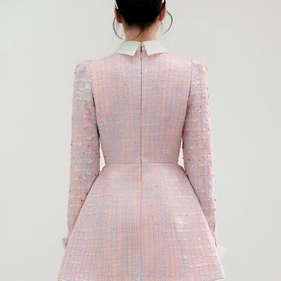 Elegant pink textured dress with floral embellishments, perfect for special occasions and fashion-forward events.