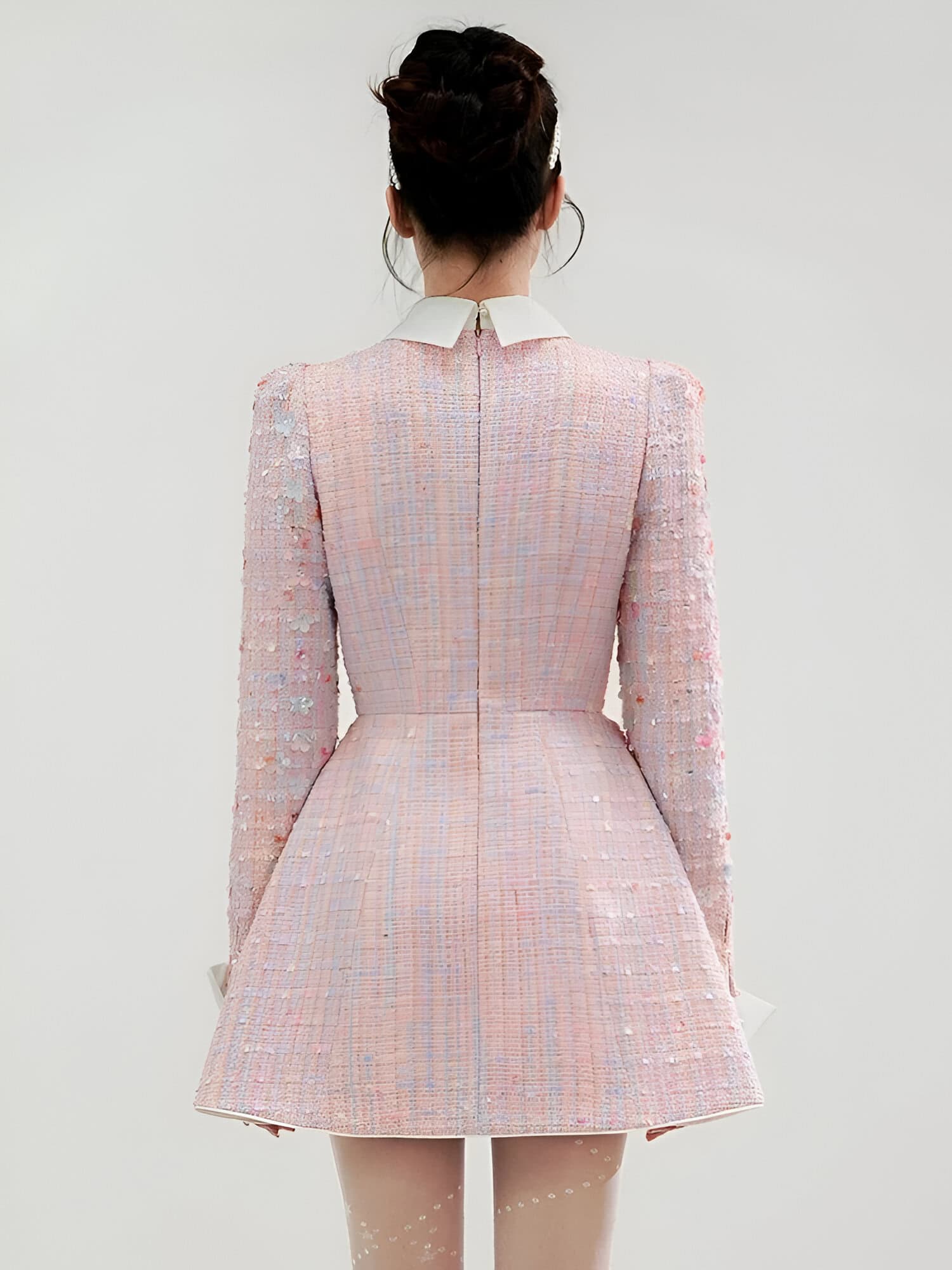 Elegant pink textured dress with floral embellishments, perfect for special occasions and fashion-forward events.