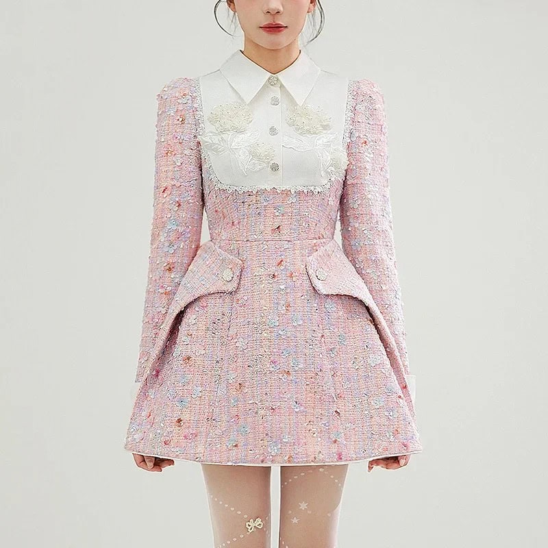 Luxurious pastel pink tweed dress with embroidered floral details, structured design, and playful hemline, perfect for elegant occasions and fashion-forward styling.