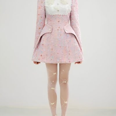 Elegant women's pink tweed coat dress with embroidery and unique tailoring, paired with sheer stockings with bows and floral designs, perfect for fashion-forward occasions.