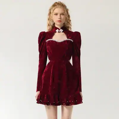 Luxurious red velvet dress with dramatic puff sleeves and embellished neckline, perfect for elegant occasions and fashion-forward women.
