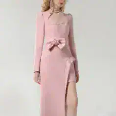 Elegant pink evening gown with lace details, bow accent, and high slit, perfect for formal occasions and weddings, available at Monalisa Medical Store.