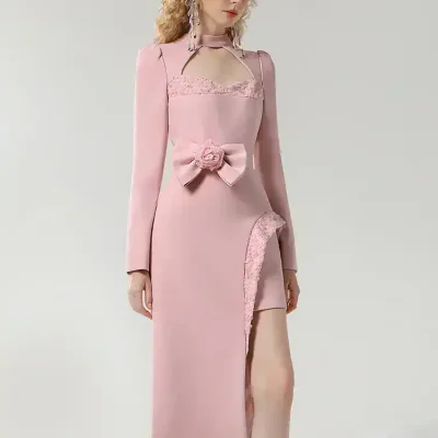 Elegant pink evening gown with lace details, bow accent, and high slit, perfect for formal occasions and weddings, available at Monalisa Medical Store.