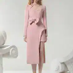 Elegant pink evening gown with floral embellishment, lace details, and high slit, perfect for formal events and special occasions. Suitable for sophisticated fashion and luxury dress shopping.