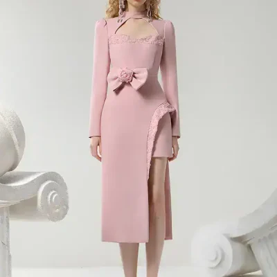 Elegant pink evening gown with floral embellishment, lace details, and high slit, perfect for formal events and special occasions. Suitable for sophisticated fashion and luxury dress shopping.