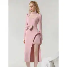 Elegant pink dress with lace detailing, high slit design, and bow accent, perfect for fashionable occasions and stylish events.