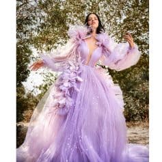 Lavender evening gown with floral embellishments, tulle fabric, and shimmering star details, perfect for special occasions and fashion shows.