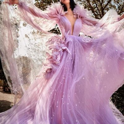 Luxurious pink evening gown with flowy tulle fabric, intricate floral details, and sparkling embellishments, perfect for formal events or weddings.