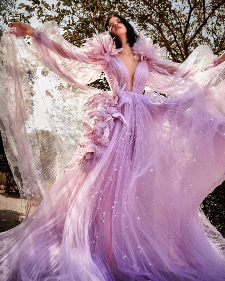 Luxurious pink evening gown with flowy tulle fabric, intricate floral details, and sparkling embellishments, perfect for formal events or weddings.