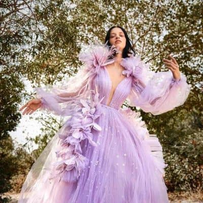 Luxurious lavender ball gown with floral embellishments, perfect for high-fashion events and photo shoots. Stunningly designed dress with sheer sleeves and intricate detailing from Monalisa Store.