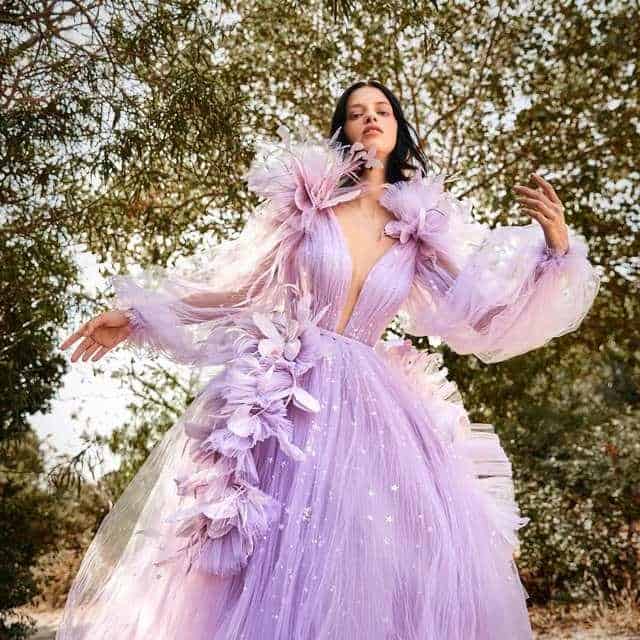 Luxurious lavender ball gown with floral embellishments, perfect for high-fashion events and photo shoots. Stunningly designed dress with sheer sleeves and intricate detailing from Monalisa Store.