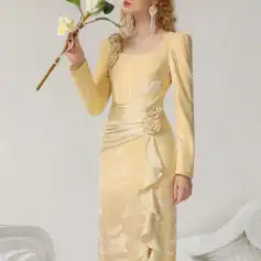 Elegant gold evening gown with floral embellishments and ruffle details, perfect for formal occasions. Designed for sophisticated style at Monalisa Medical Store.