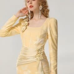 Elegant beige evening gown with floral embellishments and delicate fabric texture, ideal for special occasions at Monalisa Store, focusing on luxury women's fashion.