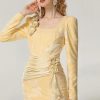 Elegant yellow dress with floral appliqué and ruched details, perfect for special occasions and fashion-forward events.