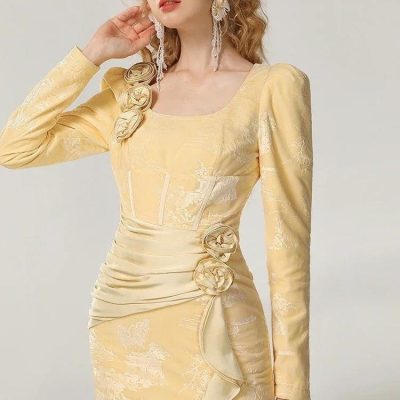 Elegant yellow dress with floral appliqué and ruched details, perfect for special occasions and fashion-forward events.