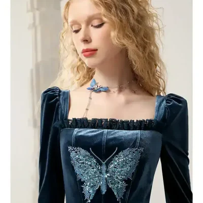 Elegant model wearing a dark blue velvet dress with butterfly embroidery, showcasing fashion and style at Monalisa Store for trendy women.