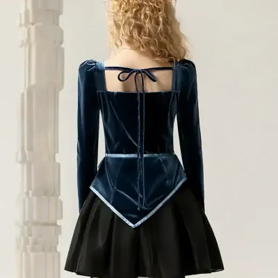 Elegant navy blue velvet top with a stylish back tie, paired with a black pleated skirt, perfect for fashionable outings and sophisticated occasions.