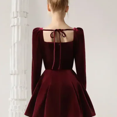 Elegant burgundy velvet dress with puff sleeves, square neckline, and bow tie detail at the back, perfect for stylish outings and special occasions.