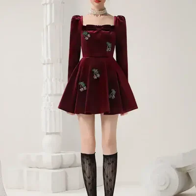 Elegant red velvet dress with embroidered floral details, perfect for fashionable women seeking luxury outfits. Ideal for special occasions and upscale events.